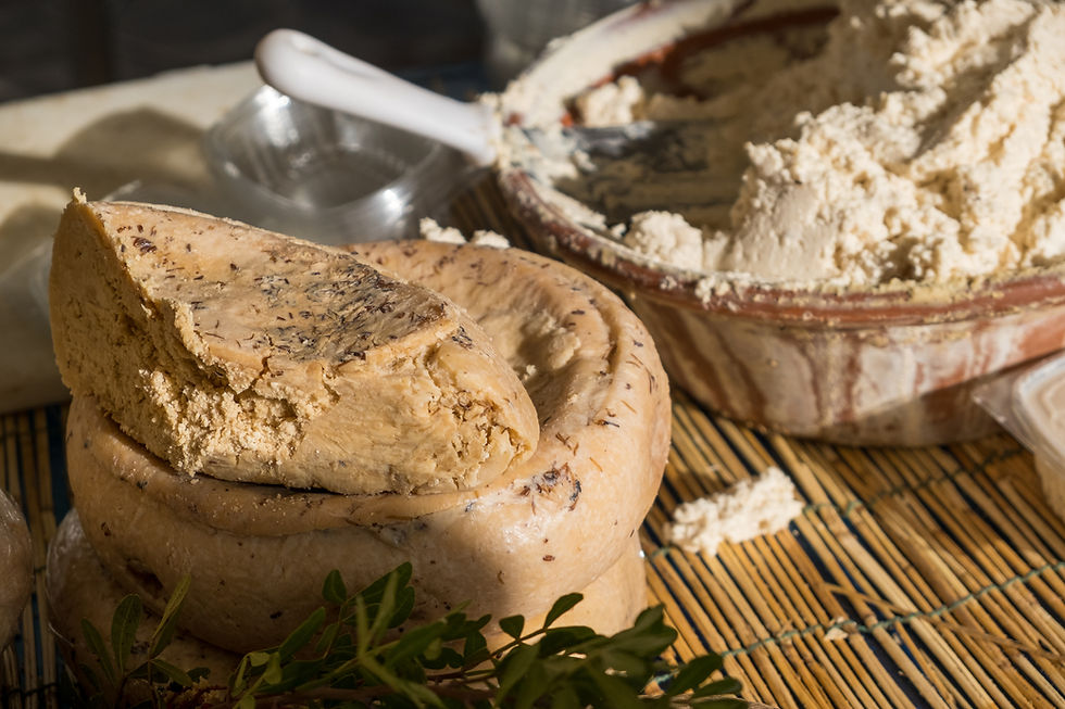 Slice of Casu Marzu on a rustic wooden board