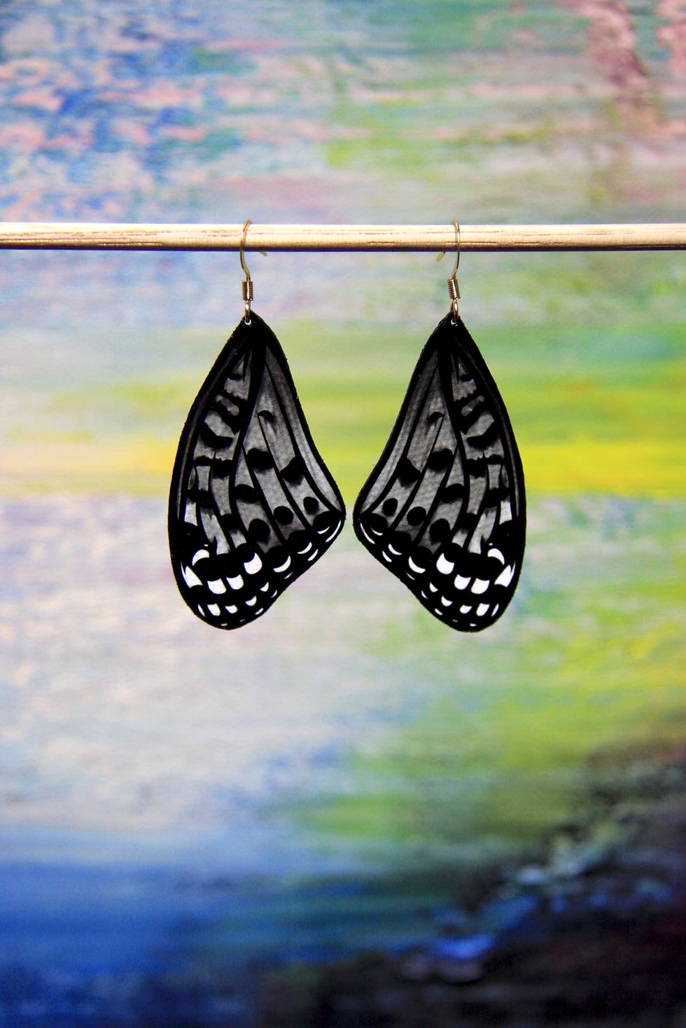 Thumbnail: Front hanging view with Abstract Art backdrop of Black and White Fritillary butterfly wings on surgical steel earring hooks
