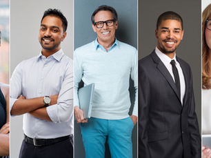 Five business professionals smiling, facing forward.
