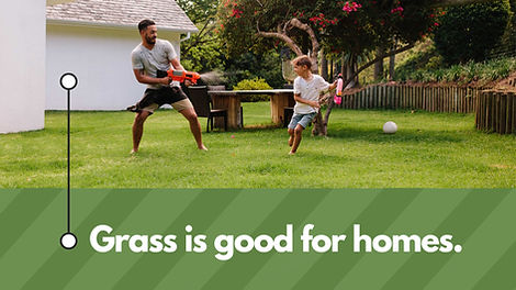 Grass is good for homes text at the bottom of image. Image shows Dad having a squirt gun fight with his son in their yard.