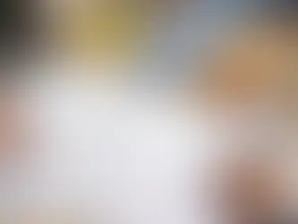 Hands reviewing a Chinese business license and factory verification checklist beside toy samples on a desk