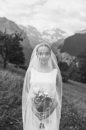 Cinematic black and white bridal portrait with a long veil in the foggy landscape of Wengen, Lauterbrunnen Civil Wedding Portraits