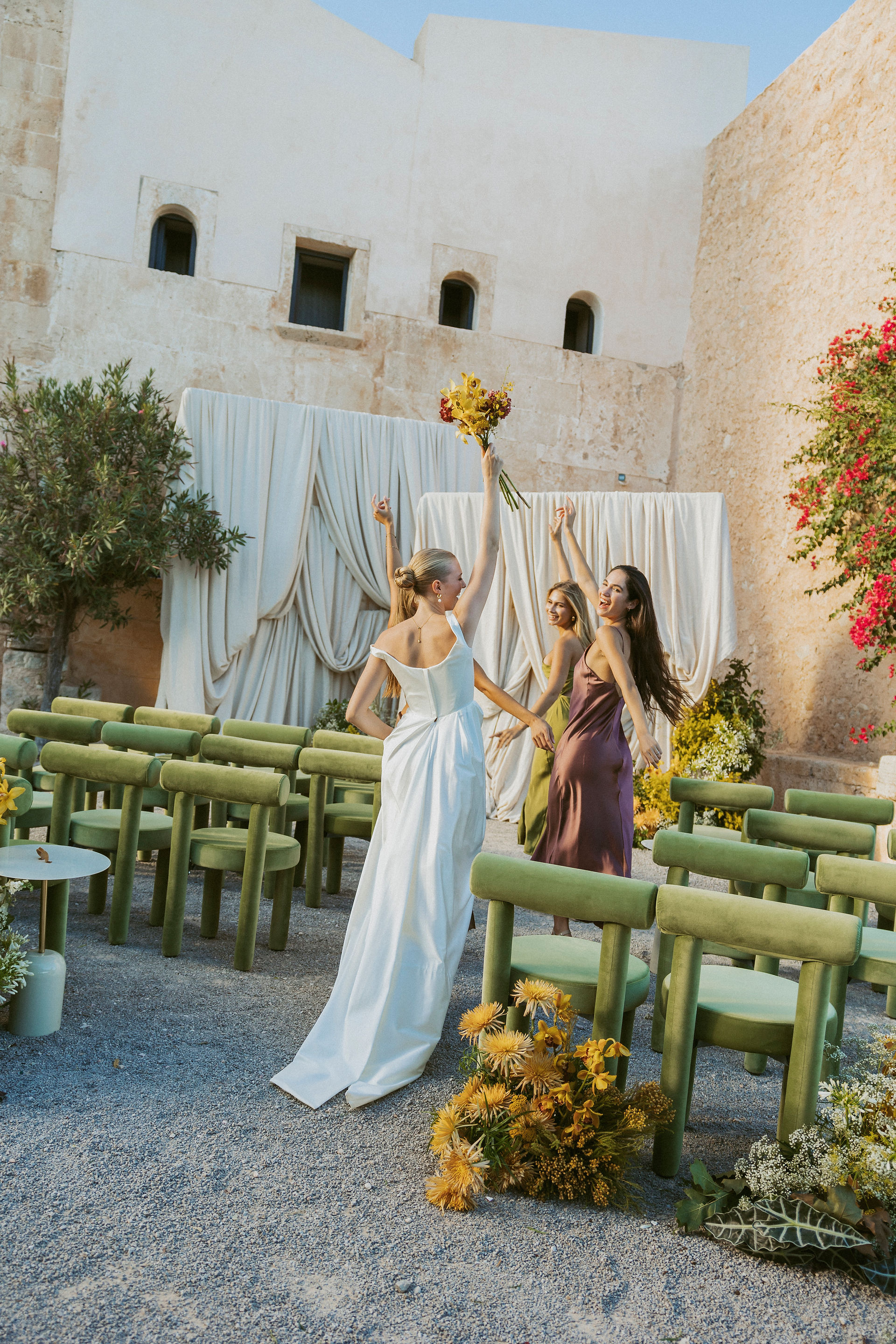 Wedding ceremony set up in front of a rustic stone building at The Lodge, Mallorca, Spain, with olive trees and Mediterranean views.