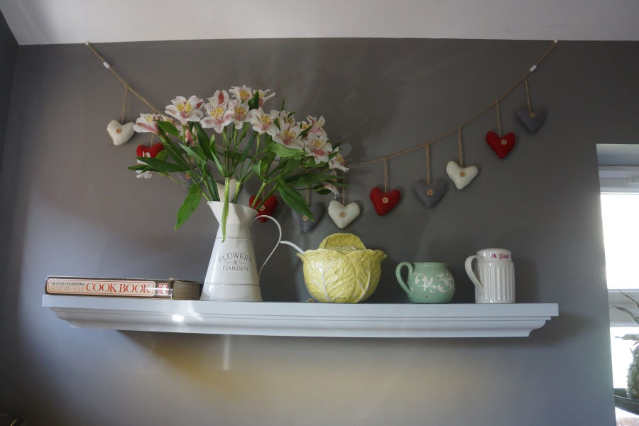Traditional styled floating kitchen shelf with integrated lighting.
