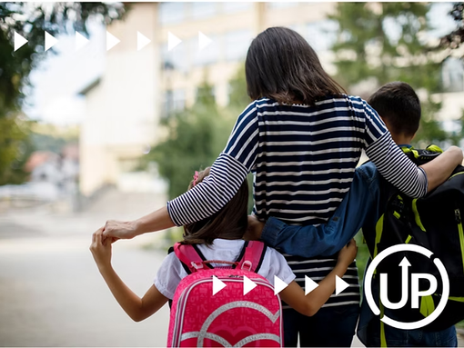 Women with kids with backpacks waiting for bus