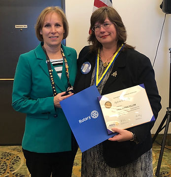 Sylvia Pauly is awarded a Paul Harris from Rotary of Newport President Julie Hanrahan.