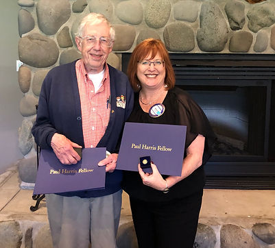 John Baker and Megan Schain earn their Paul Harris Fellow +3.