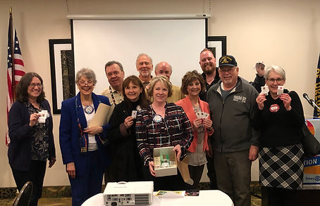 Sunnetta Capovilla hands out seeds to Newport Rotarians to create healthy habitats.