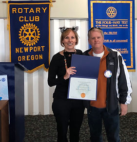 Newport Rotary President Julie Hanrahn awards Dave Heater a Paul Harris Fellow.