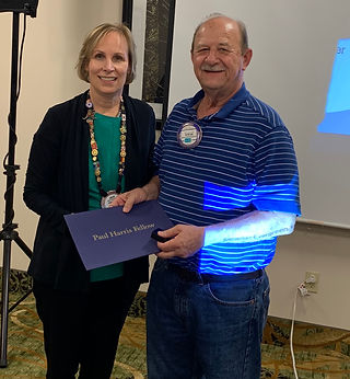 President Hanrahan awards Steve Johnson his Paul Harris Fellow +4.