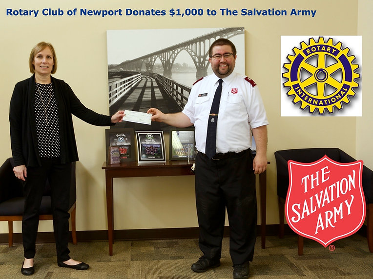 Newport Rotary President Julie Hanrahan presents a check for $1,000 to Lieutenant Nathan Perry of the Salvation Army of Lincoln County.