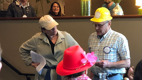 Caroline Bauman and Bob Wienert performing in a skit at a Rotary of Newport meeting.