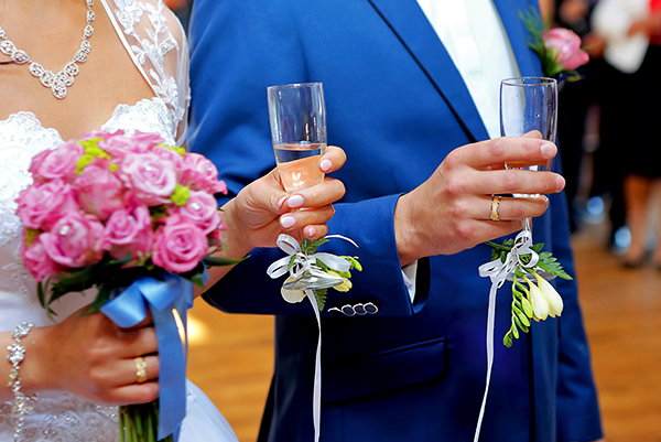 Bride and groom toasting with champagne flutes at wedding