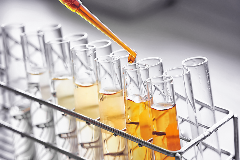 Pipette dripping liquid into a rack of test tubes