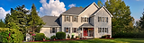 Large two-story house with grey siding and asphalt roof