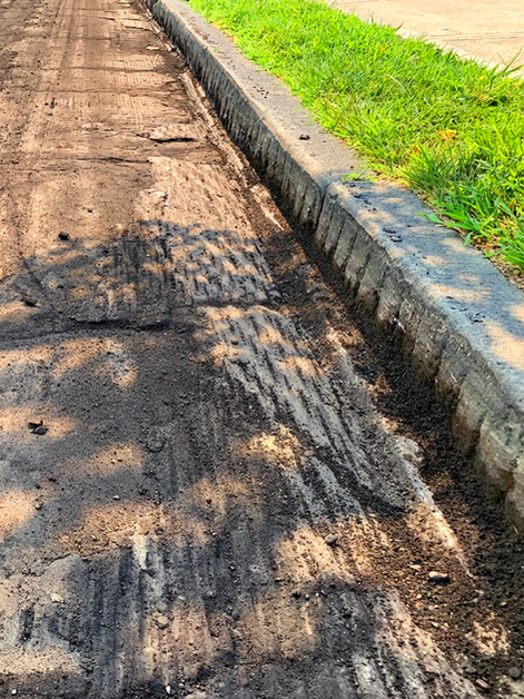 Damaged asphalt driveway with cracks