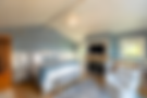Spacious bedroom with fireplace, TV, and built-in shelving