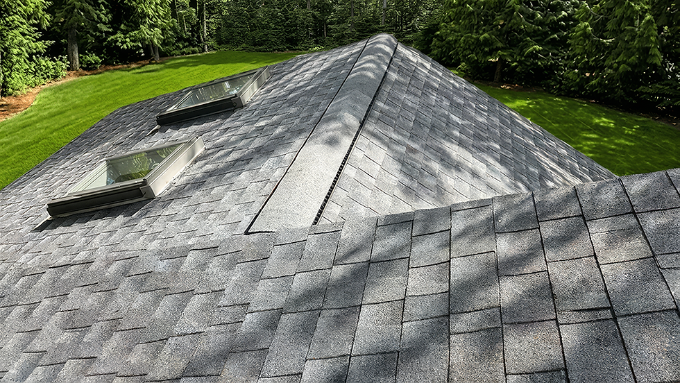 Grey asphalt shingle roof with skylights and ridge vent