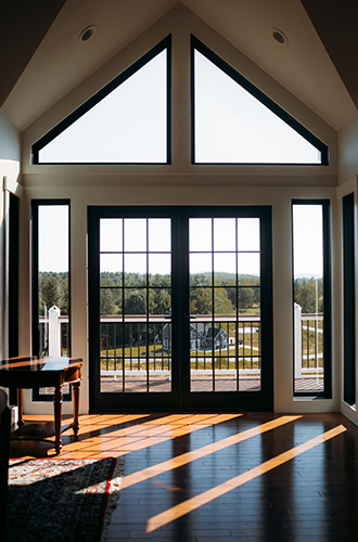 Sunlit room with expansive windows and patio doors