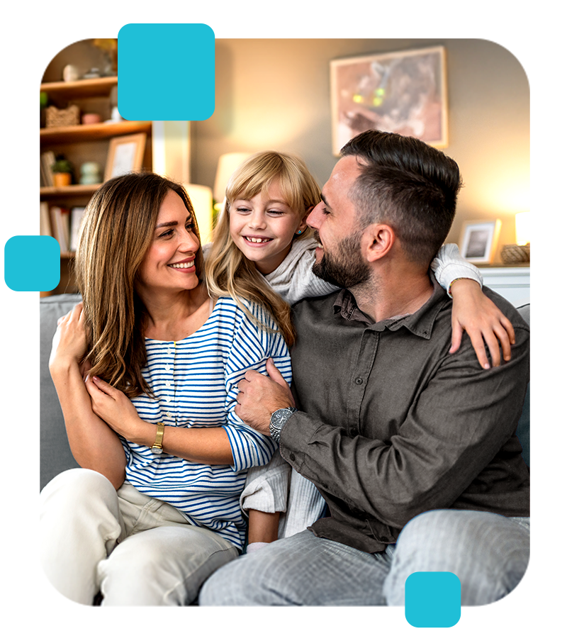 Family sitting together, smiling, embracing. Home, cozy living room setting.