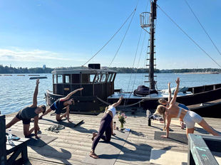 Yoga session at the pier with docked Ark