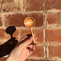 a coffee scoop on a background of exposed red brick