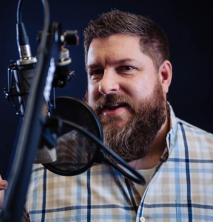 Mike Cunningham speaking into a microphone, Mike Cunningham VO for professional audio.