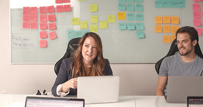 Two sales people working in a meeting wi