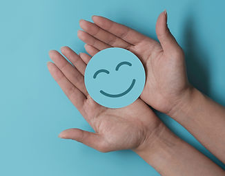 Hand holding paper cut smile face, positive thinking, mental health assessment , world men