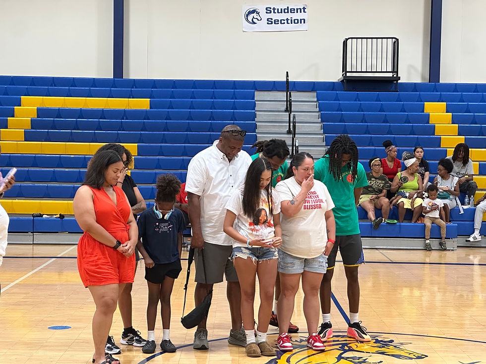 Players and spectators paused before the second game to honor Micki Wells, remembered by the Carroll family as a loving supporter who consistently lifted others.