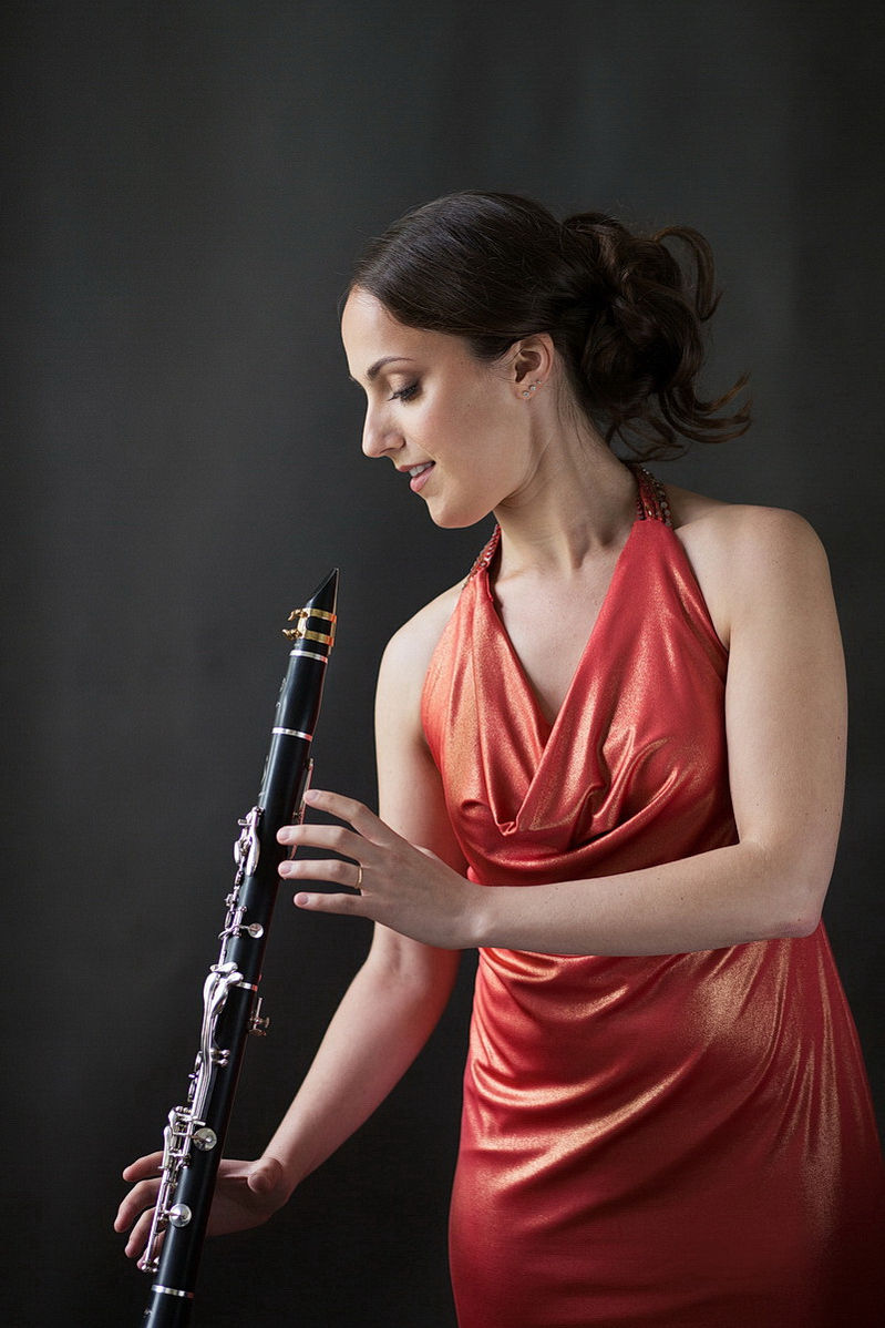 Woman in red dress holding a clarinet