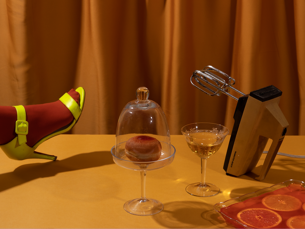 Composition of female feet wearing high heel shoe and a donut in a fancy glass plate