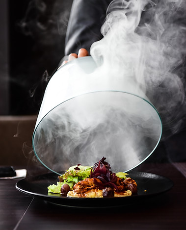 Smokey reveal of cloche to present plate of food