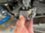 Thumbnail: Hands installing motorcycle shock reservoir