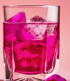 rocks glass filled with a fuschia liquid over ice.jpg