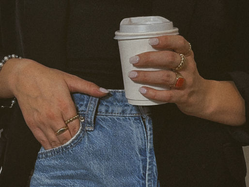 Woman holding cup of coffee.