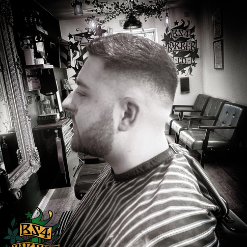 mid skin fade and beard shape up.