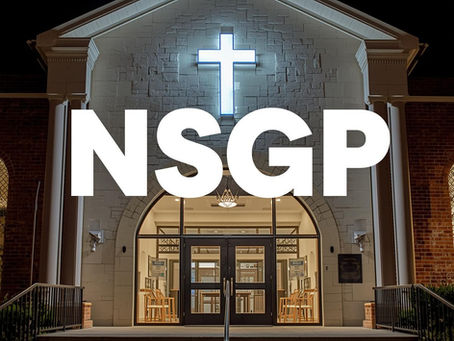 A brightly lit Pentecostal church, its facade detailed with visible security cameras, robust reinforced doors, and elements suggesting emergency preparedness. Bold, clear “NSGP” text is overlaid prominently on the image, signifying proactive protection and funding for faith-based congregations confronting increasing security challenges.