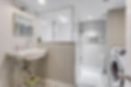 Bathroom with shower and laundry in lower-level Toronto suite