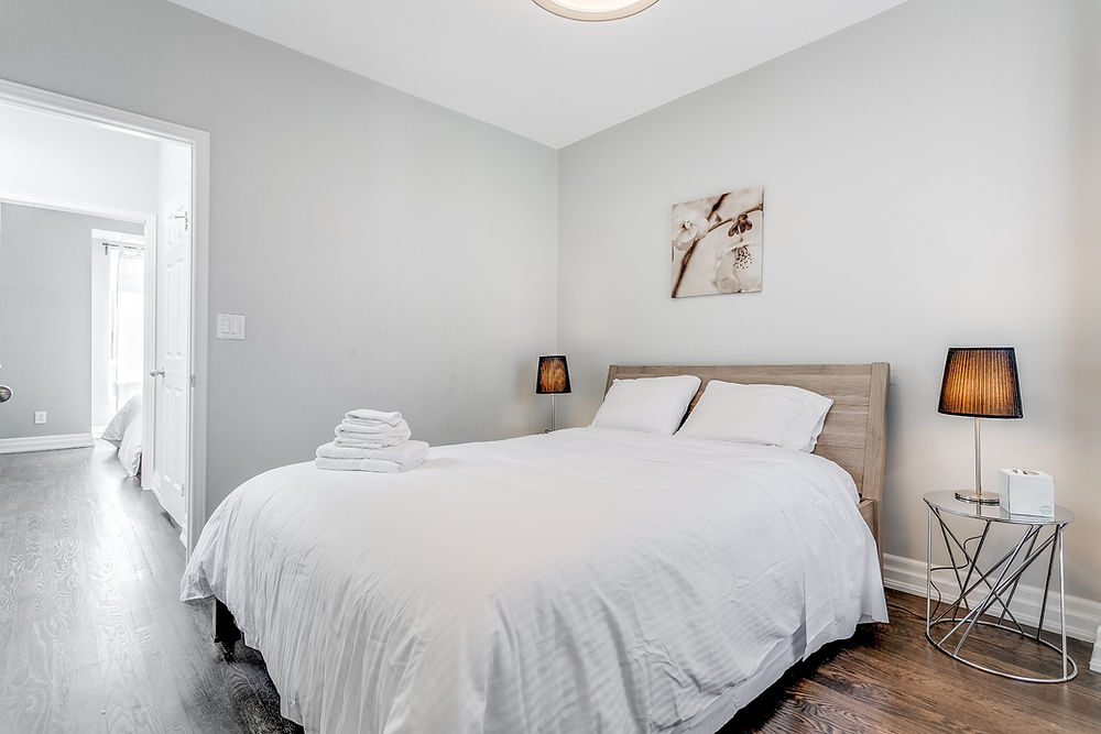 13. Cozy bedroom with window and clean bedding in Toronto short term rental