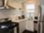 Kitchen with gas stove and fridge
