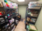 Storage closet with two large shelves full of bins