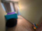 Calming space including beanbag, basket of fidgets, fuzzy rug, and large lycra box
