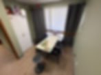 Room with storage cabinet and table with colorful circular visual perceptual puzzle