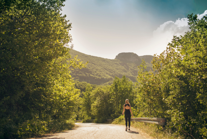 Woman walking in nature for mental wellbeing and digital detox benefits