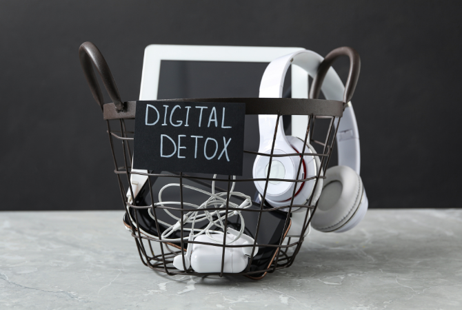 Stack of smartphones, tablets and laptop representing digital overload and need for a digital detox
