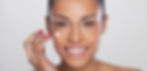 Female customer having a green face mask applied to her face