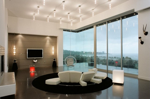 Modern living room interior design with large windows.
