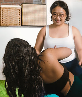 Women fitness trainer teaching women student pilates