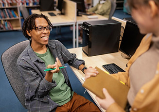 young-colleagues-talking-library.jpg